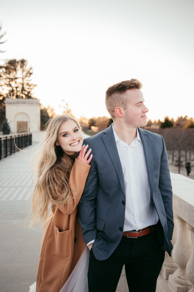 Makeup for engagement photoshoot, future bride with future groom smiling on a bridge.